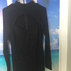 Black long sleeve Fashion Nova jumpsuit with a little cut out in the chest area.